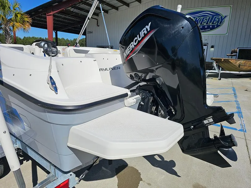 Slide: The Image of 2021 Bayliner Element E18 boat with Mercury outboard motor, parked outdoors. - 8