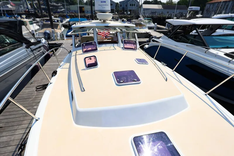 Slide: The Image of 2010 MJM 40z Downeast boat docked, showcasing deck and hatches. - 12