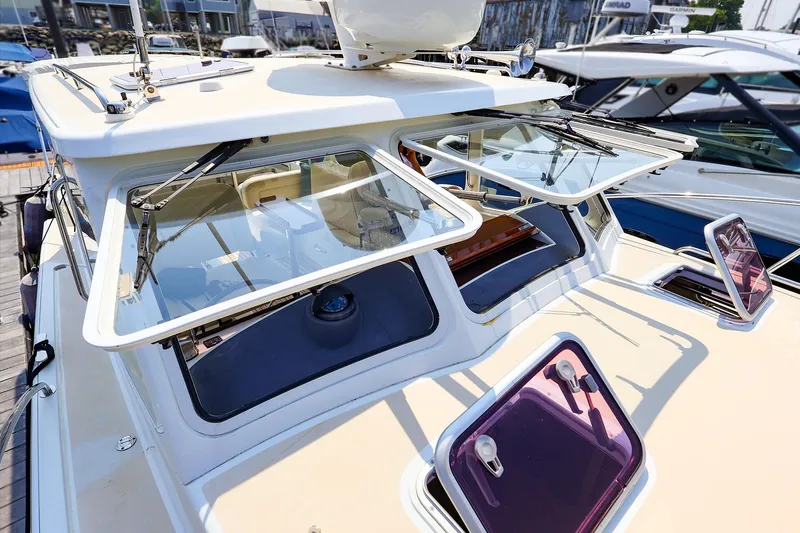 Slide: The Image of 2010 MJM 40z Downeast boat with open windows, docked at a marina. - 14