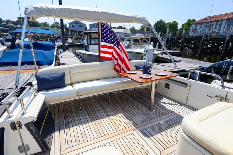 Slide: The Image of Luxurious 2010 MJM 40z Downeast yacht with elegant seating and American flag at marina. - 19