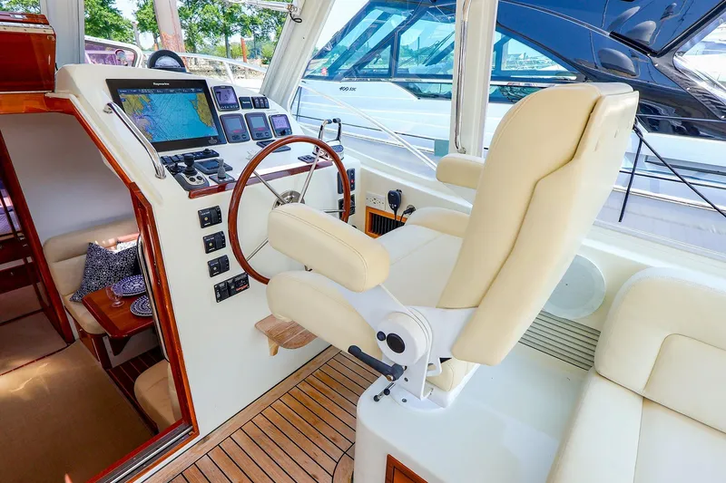 Slide: The Image of Helm of 2010 MJM 40z Downeast yacht with navigation equipment and plush seating. - 25