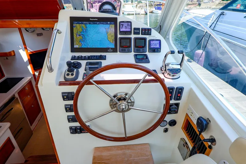 Slide: The Image of Helm of 2010 MJM 40z Downeast boat with navigation equipment and wooden steering wheel. - 26