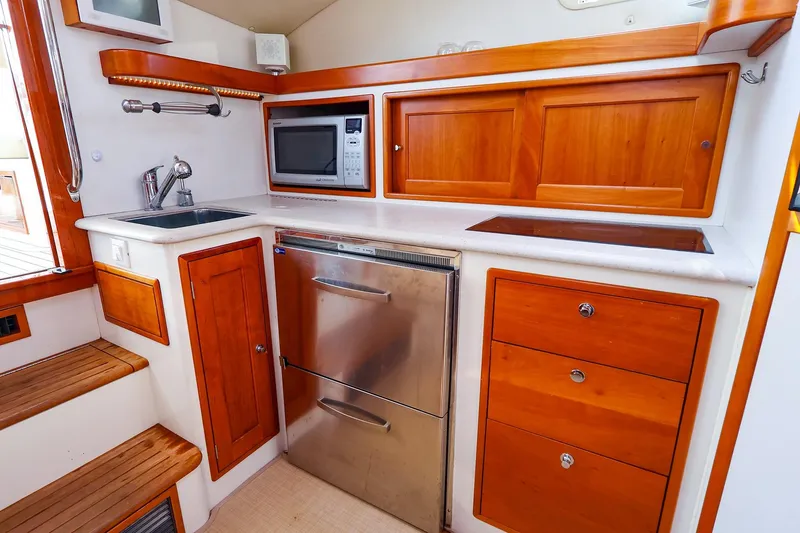 Slide: The Image of Compact galley in 2010 MJM 40z Downeast boat with wood cabinetry and stainless steel appliances. - 39