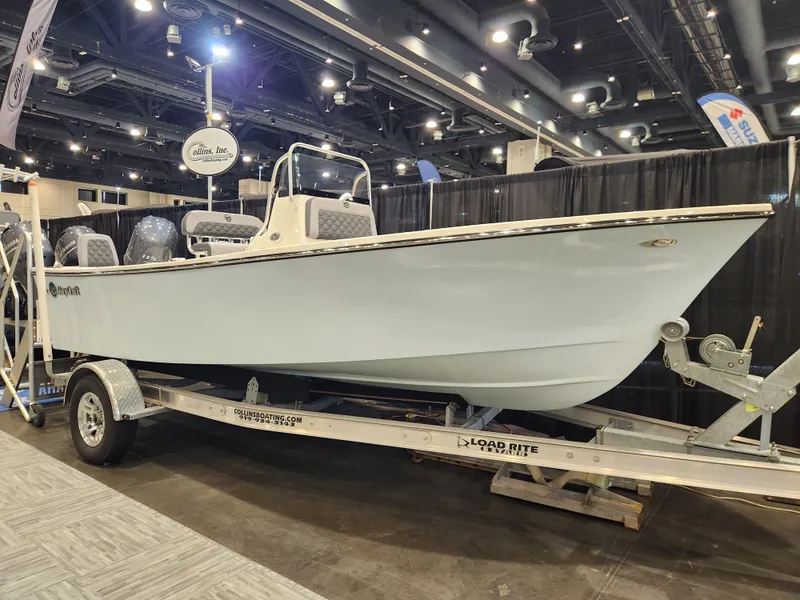 Slide: The Image of 2025 May-Craft 192 CC boat on trailer, parked outdoors with trees in background. - 1