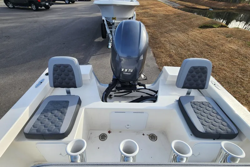 Slide: The Image of 2025 May-Craft 192 CC boat interior with seating and outboard motor. - 14