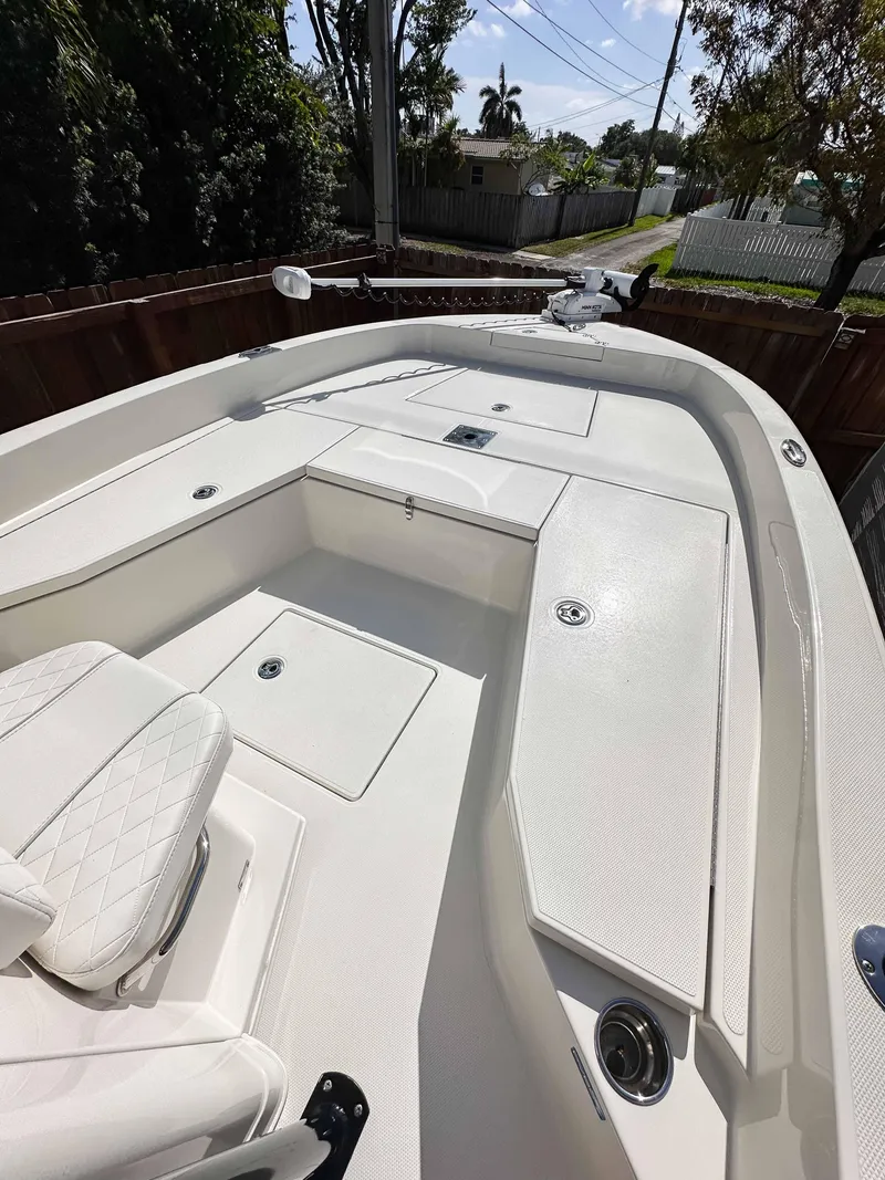 Slide: The Image of 2023 Ranger 2360 Bay boat with spacious deck and seating, ideal for fishing and leisure. - 17