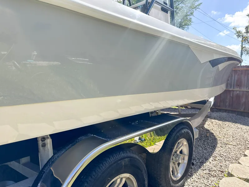 Slide: The Image of 2023 Ranger 2360 Bay boat on trailer, side view in sunlight. - 24