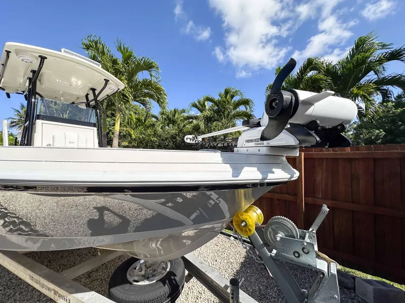 Slide: The Image of 2023 Ranger 2360 Bay boat on trailer, sunny day, palm trees in background. - 4