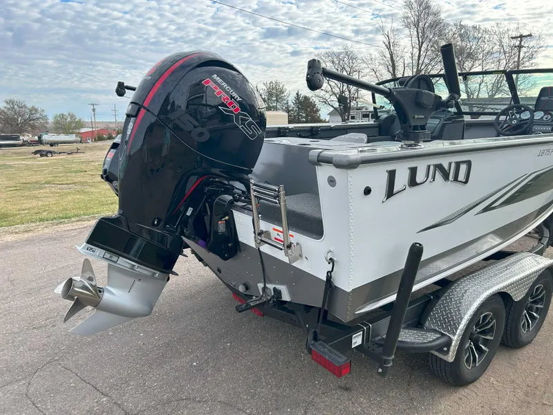 Slide: The Image of 2024 Lund 1875 Fisherman boat with powerful outboard motor on a trailer. - 5