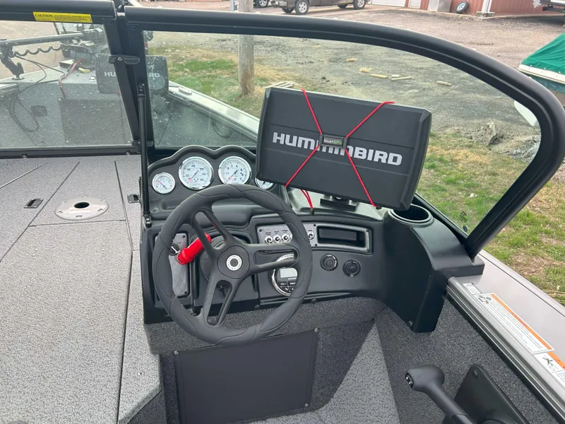 Slide: The Image of 2024 Lund 1875 Fisherman boat dashboard with Humminbird electronics and steering wheel. - 9