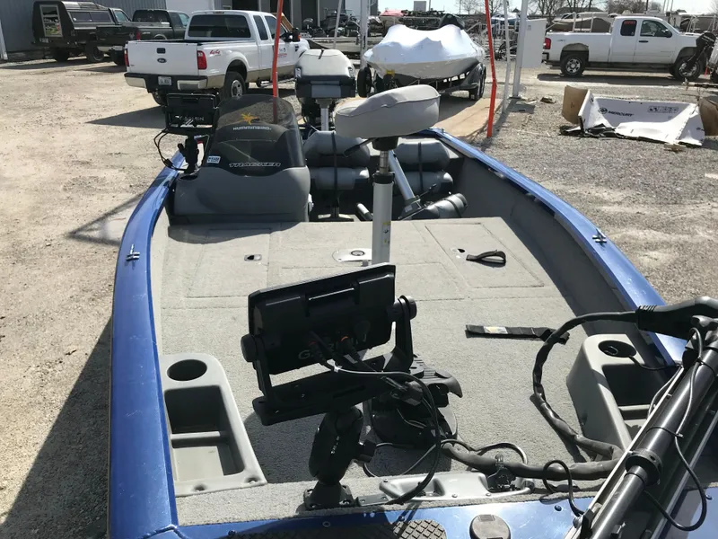 Slide: The Image of 2012 Tracker Pro Team 175 TF boat with fishing equipment, parked outdoors. - 18