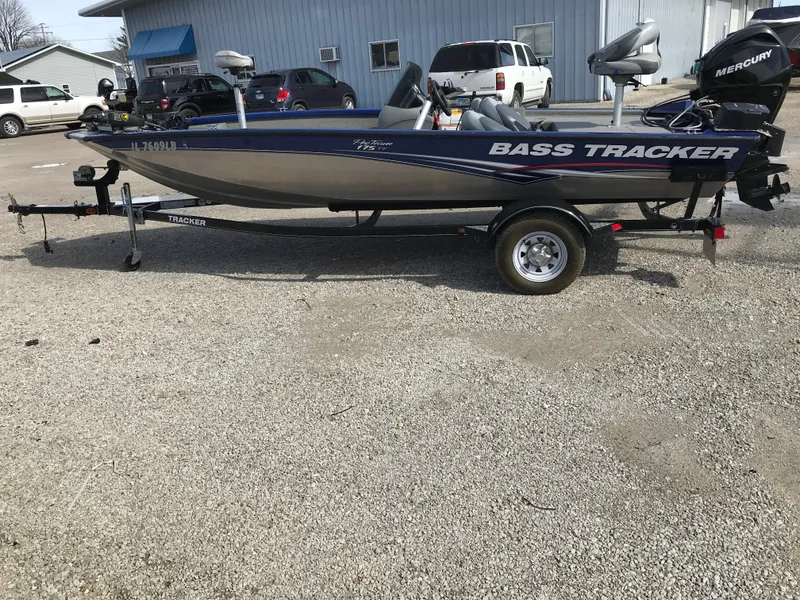 Slide: The Image of 2012 Tracker Pro Team 175 TF bass boat on trailer, parked outdoors. - 3