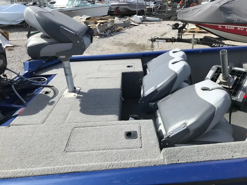 Slide: The Image of 2012 Tracker Pro Team 175 TF boat interior with gray seating and storage compartments. - 9