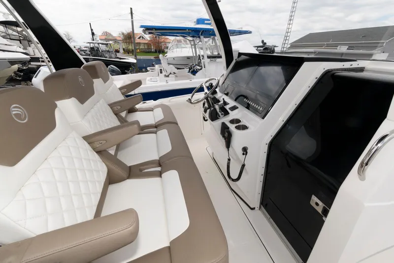 Slide: The Image of 2017 Edgewater 368CC boat interior with modern helm and cushioned seating. - 16