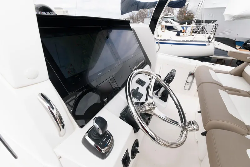 Slide: The Image of 2017 Edgewater 368CC boat helm with modern controls and steering wheel. - 19