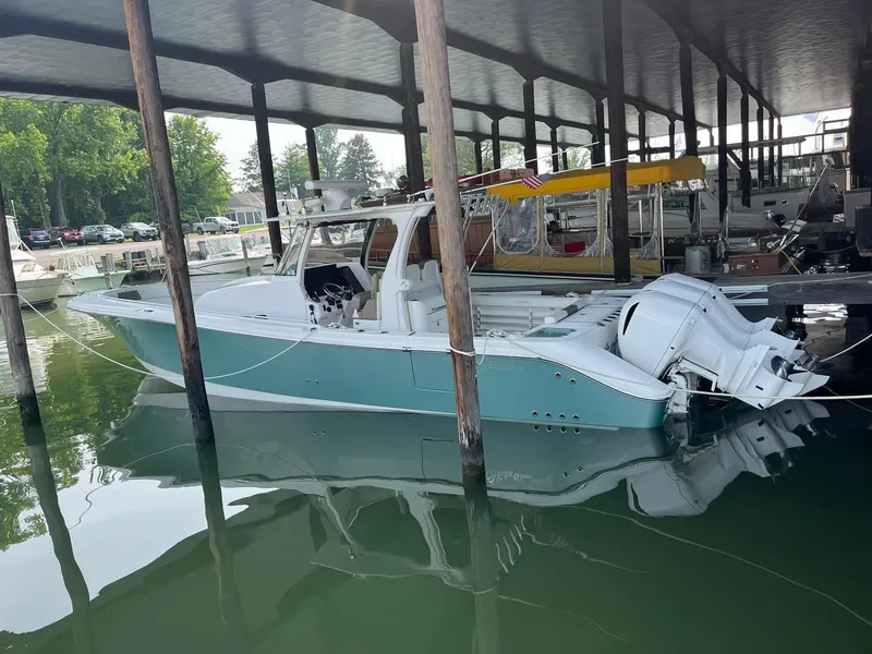 Slide: The Image of 2017 Edgewater 368CC boat docked in a covered marina. - 2