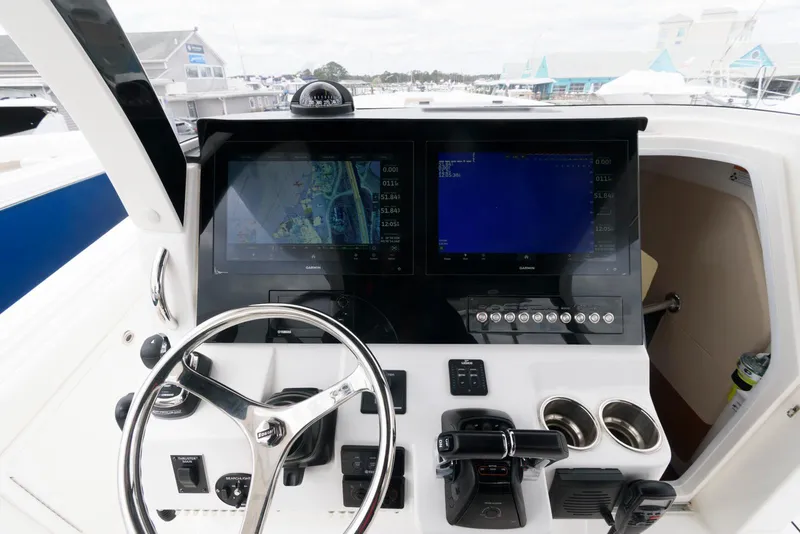 Slide: The Image of 2017 Edgewater 368CC boat dashboard with dual screens and steering wheel. - 20
