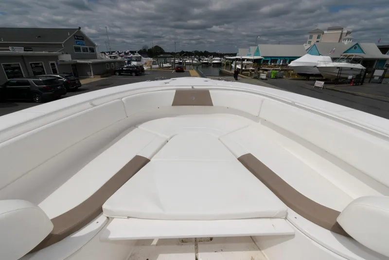 Slide: The Image of 2017 Edgewater 368CC boat with spacious deck and seating at a marina. - 24