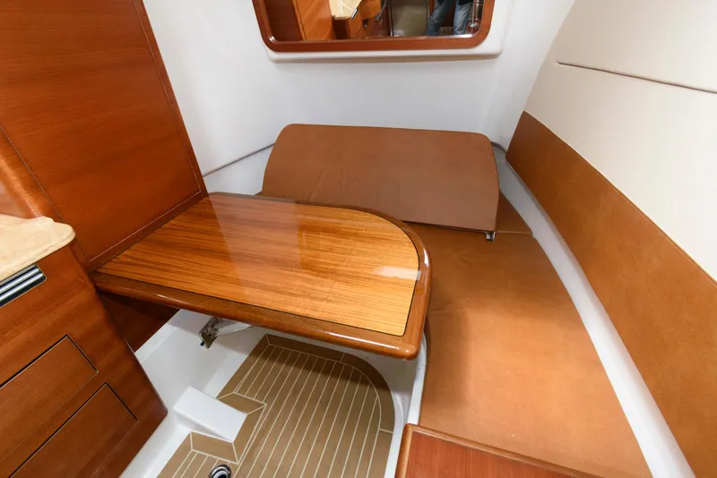 Slide: The Image of 2017 Edgewater 368CC cabin interior with wooden table and seating area. - 32