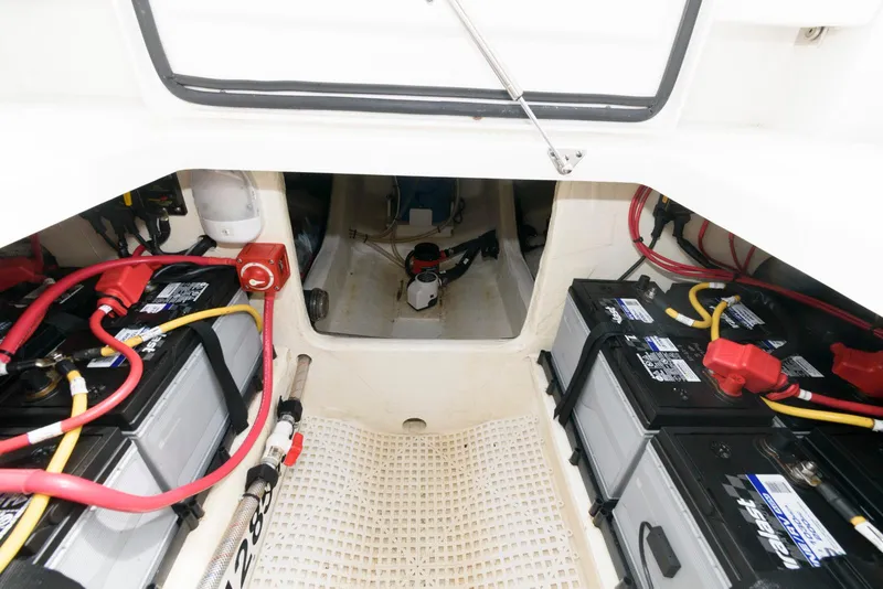 Slide: The Image of 2017 Edgewater 368CC boat battery compartment with multiple batteries and wiring. - 36