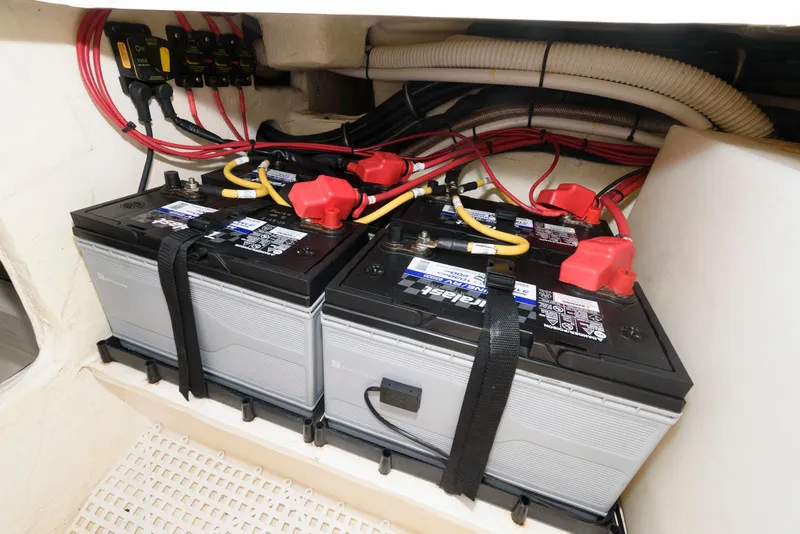Slide: The Image of Batteries installed in a 2017 Edgewater 368CC boat, secured with straps and connected with cables. - 37