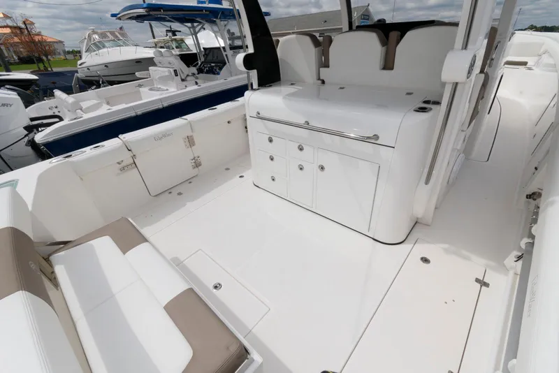Slide: The Image of 2017 Edgewater 368CC boat interior with white seating and storage compartments. - 9