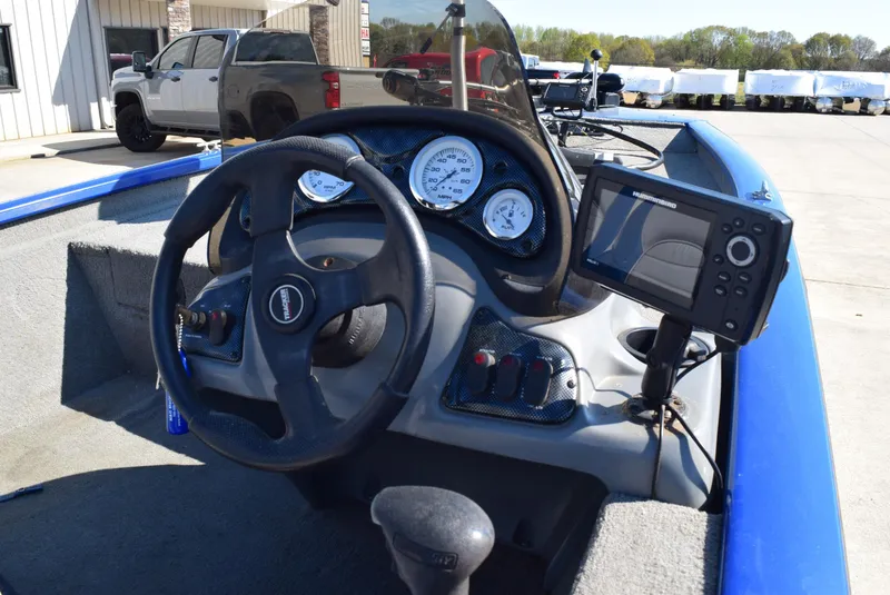 Slide: The Image of 2006 Tracker Pro Team 175 TX boat dashboard with steering wheel and navigation system. - 11