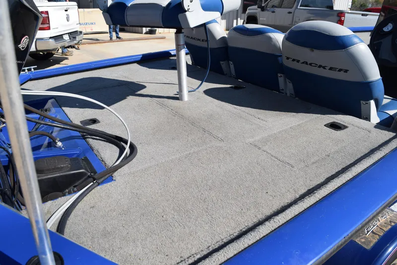 Slide: The Image of 2006 Tracker Pro Team 175 TX boat interior with blue and gray seating. - 12