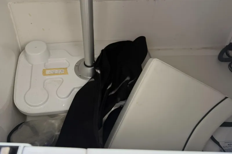 Slide: The Image of Storage compartment in a 2022 Sea Pro 2400 SC DECK boat with various items. - 2
