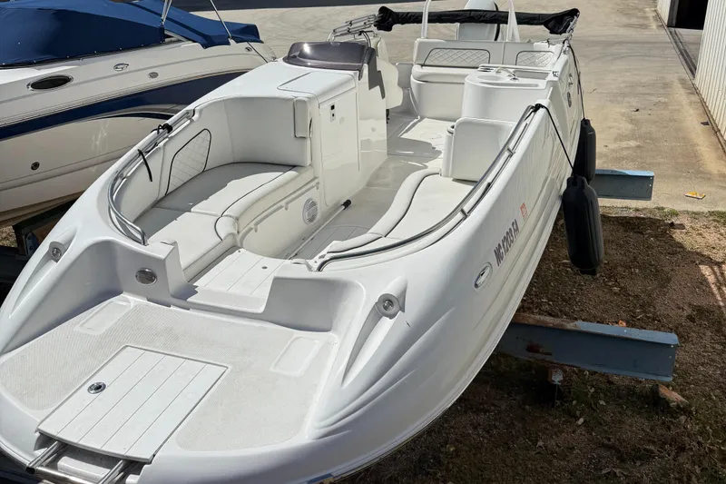 Slide: The Image of 2022 Sea Pro 2400 SC DECK boat, white exterior, docked on land. - 5