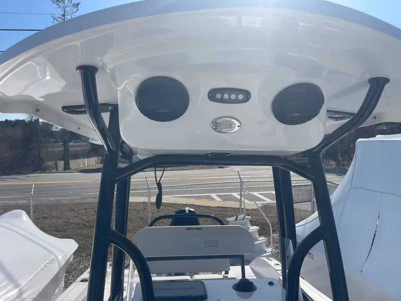 Slide: The Image of 2025 Sea Pro 225 Sandbar boat interior with T-top and speakers. - 14