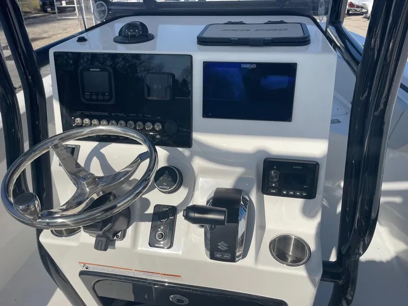 Slide: The Image of 2025 Sea Pro 225 Sandbar boat dashboard with steering wheel and control panel. - 4