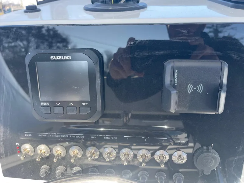 Slide: The Image of Control panel of 2025 Sea Pro 225 Sandbar boat with Suzuki display and switches. - 6