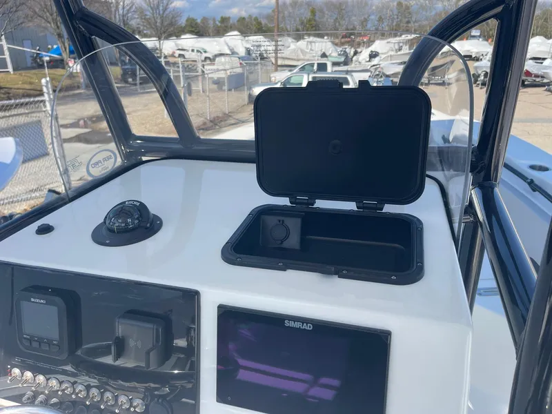 Slide: The Image of 2025 Sea Pro 225 Sandbar boat dashboard with navigation equipment and storage compartment. - 7