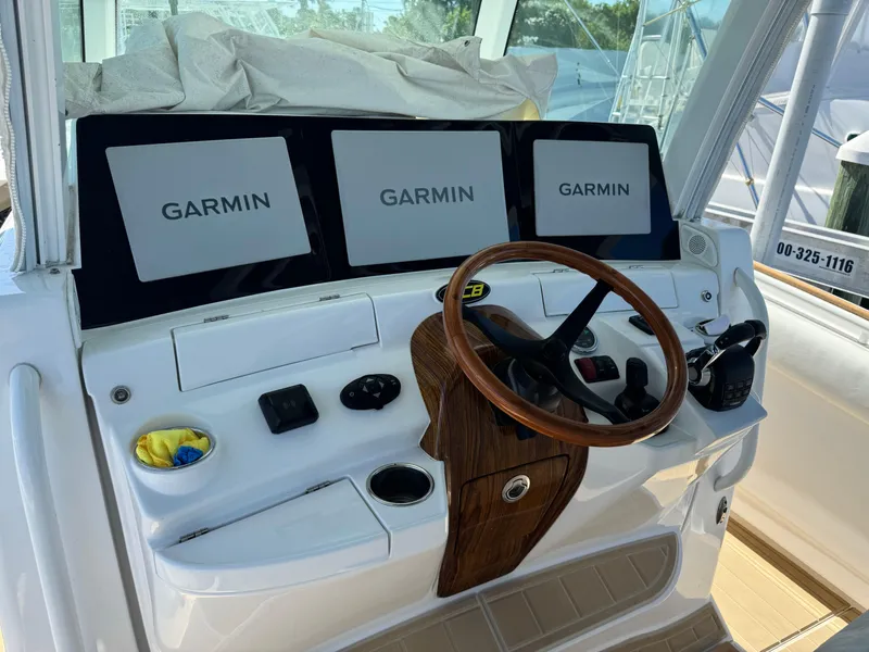 Slide: The Image of Helm of 2020 HCB 42 Lujo with Garmin displays and wooden steering wheel. - 11