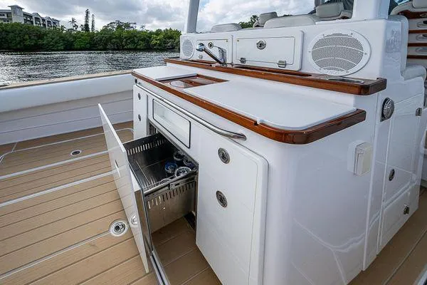 Slide: The Image of 2020 HCB 42 Lujo boat interior with open storage, sleek design, and water view. - 14