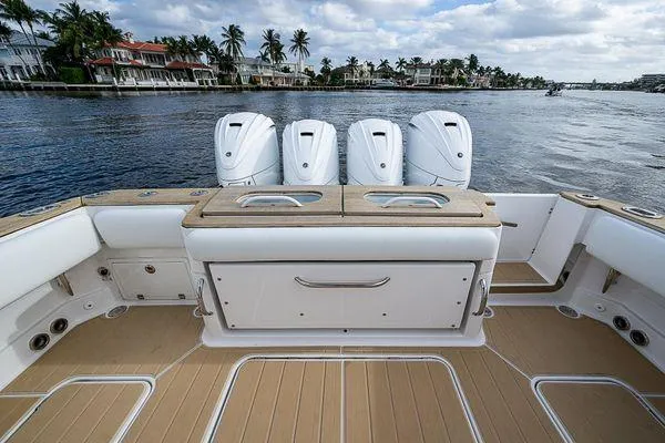 Slide: The Image of 2020 HCB 42 Lujo boat with four powerful engines, docked by waterfront homes. - 15