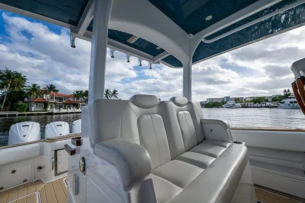 Slide: The Image of Luxurious seating on 2020 HCB 42 Lujo boat, with waterfront view and blue sky. - 16
