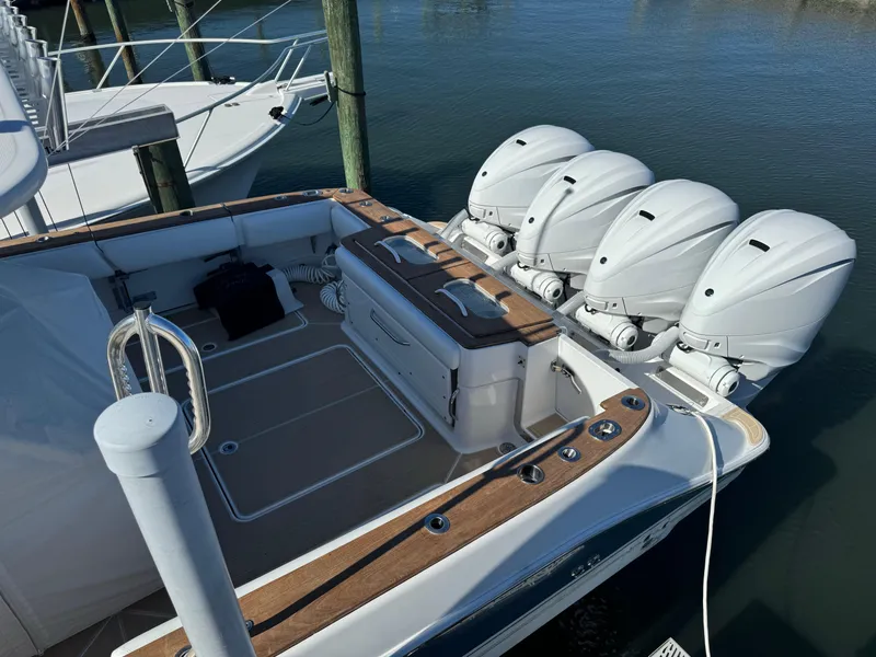 Slide: The Image of 2020 HCB 42 Lujo boat with four powerful outboard engines docked at marina. - 2