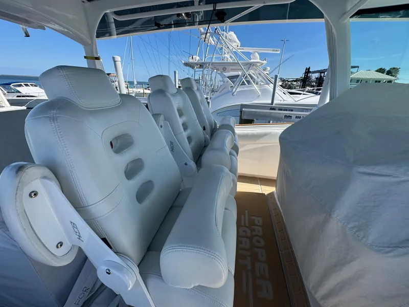 Slide: The Image of 2020 HCB 42 Lujo boat with luxurious white seating at a marina. - 7