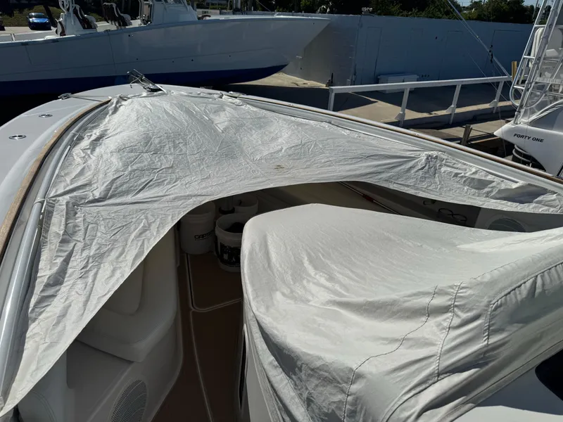 Slide: The Image of 2020 HCB 42 Lujo boat with protective cover, docked at marina. - 8
