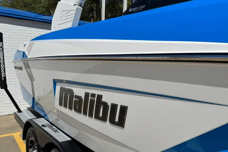 Slide: The Image of 2019 Malibu Wakesetter 23 LSV boat, blue and white exterior, parked on trailer. - 12