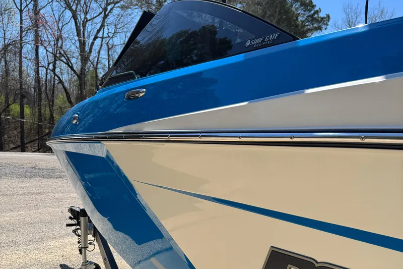 Slide: The Image of 2019 Malibu Wakesetter 23 LSV boat, blue and white exterior, parked outdoors. - 13
