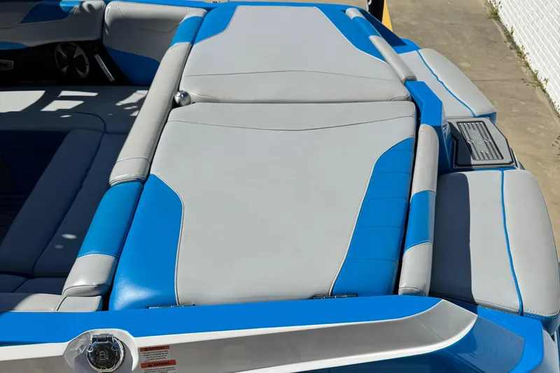 Slide: The Image of 2019 Malibu Wakesetter 23 LSV boat with blue and gray seating. - 15