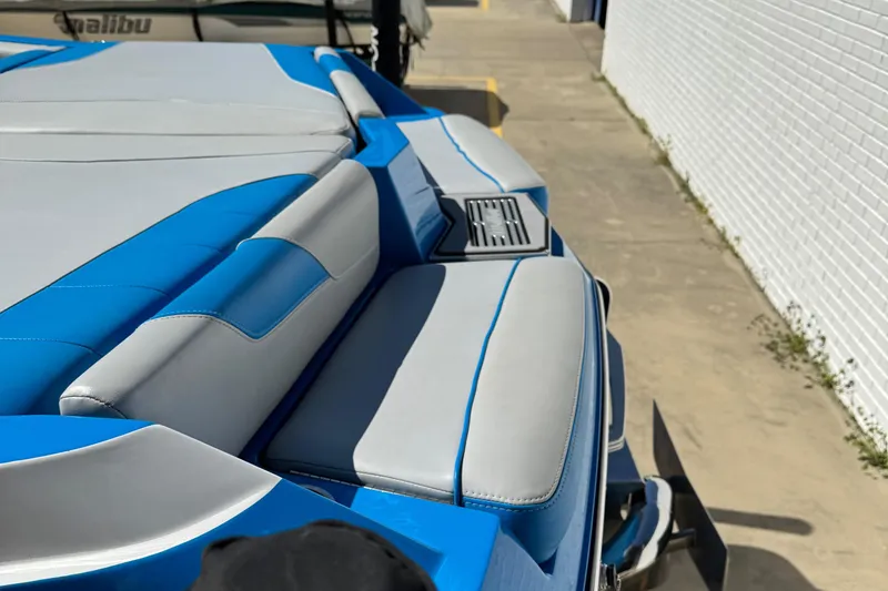 Slide: The Image of 2019 Malibu Wakesetter 23 LSV boat with blue and gray seating detail. - 17