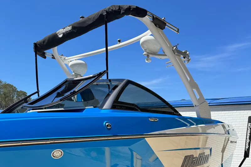 Slide: The Image of 2019 Malibu Wakesetter 23 LSV boat with blue exterior and wakeboard tower. - 3