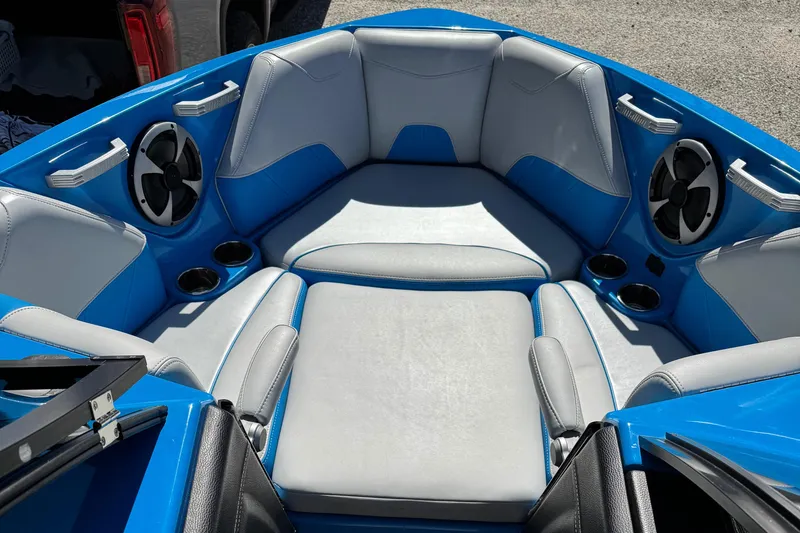 Slide: The Image of 2019 Malibu Wakesetter 23 LSV interior with blue and gray seating, cup holders, and speakers. - 8