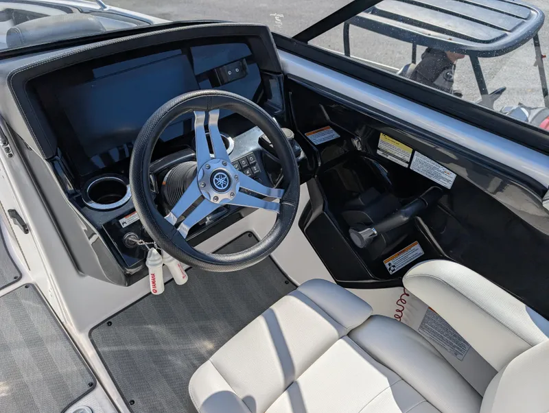 Slide: The Image of 2019 Yamaha Boats 242 Limited S cockpit with steering wheel and dashboard controls. - 13