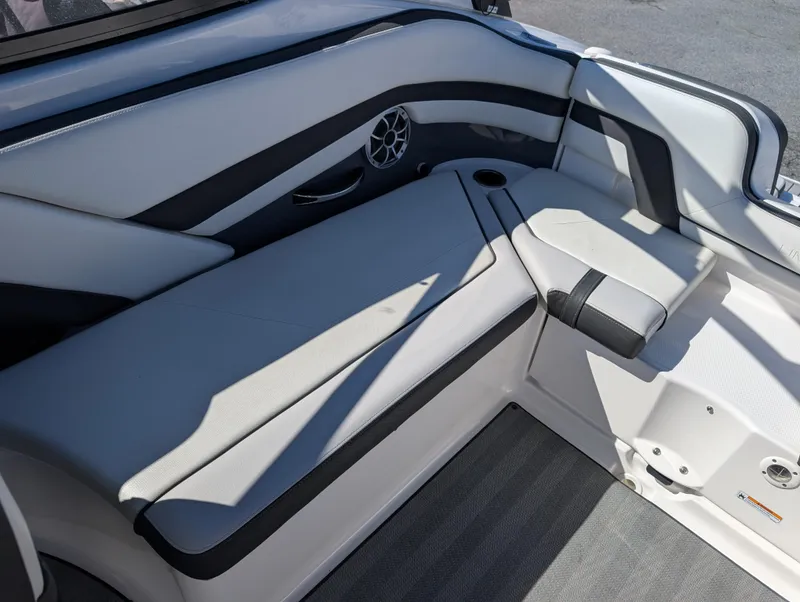Slide: The Image of 2019 Yamaha Boats 242 Limited S interior seating with sleek design and speaker. - 14