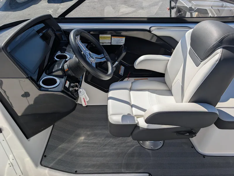 Slide: The Image of 2019 Yamaha Boats 242 Limited S cockpit with steering wheel and captain's chair. - 17